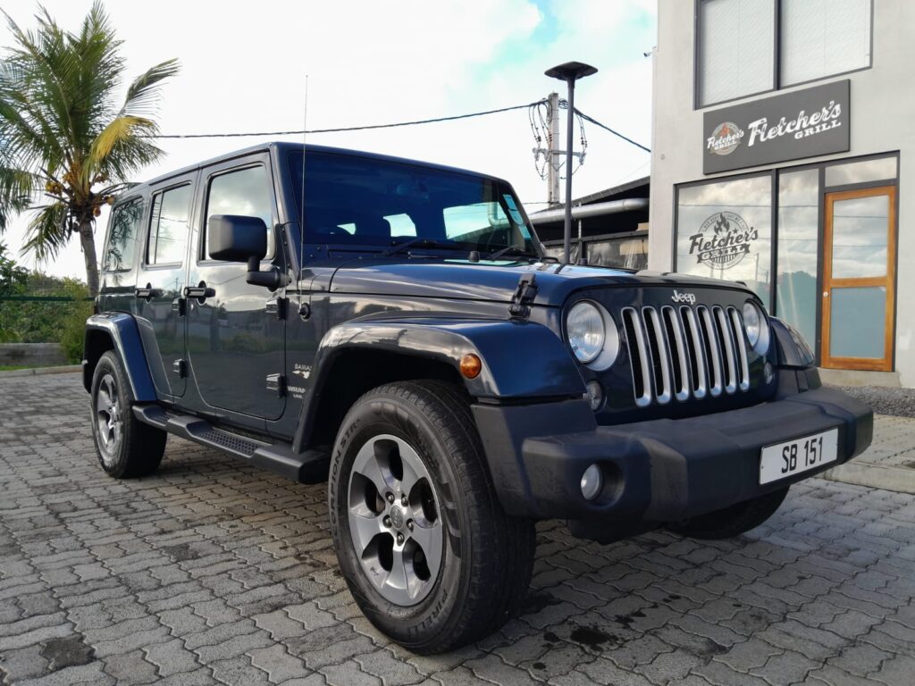 "Jeep Wrangler from Liberta Car Rental Mauritius parked near SSR Airport โ premium 4x4 car rental in Mauritius for island explorers."