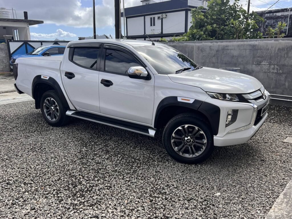 A Mitsubishi Triton 4x4 driving along the rugged terrain of Mauritius, perfect for off-road adventures and exploration.