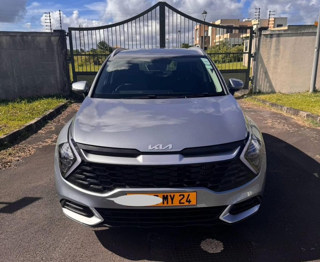 Liberta Car Rental Mauritius – Kia Sportage SUV parked by a palm-lined coastal road, ready for safe, comfortable island drives