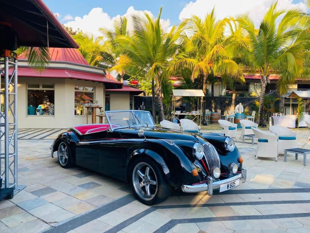 1965 Jaguar XK120 convertible in sleek silver, perfect for a stylish wedding entrance