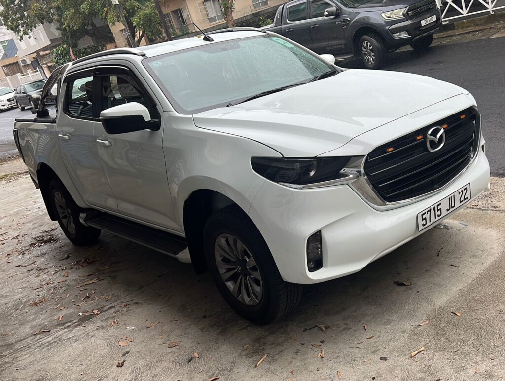 Mazda BT50 Manual parked on a rugged trail in Mauritius, showcasing its robust design and off-road capabilities, available for rent at Liberta Car Rental.