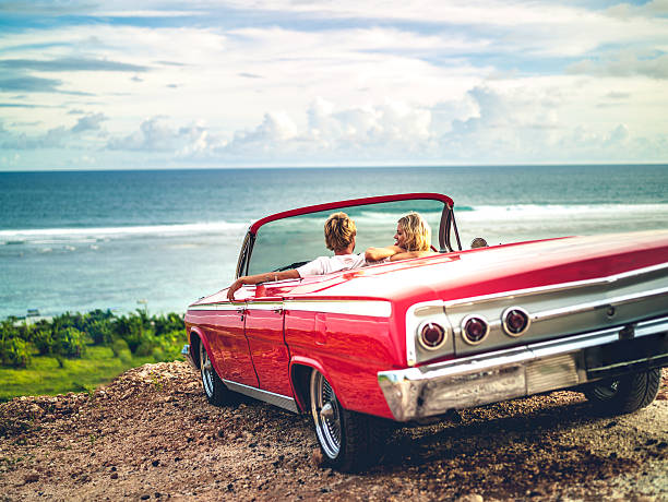 Elegant vintage wedding car, the Rolls Royce Silver Shadow, parked in front of a picturesque chapel in Mauritius.