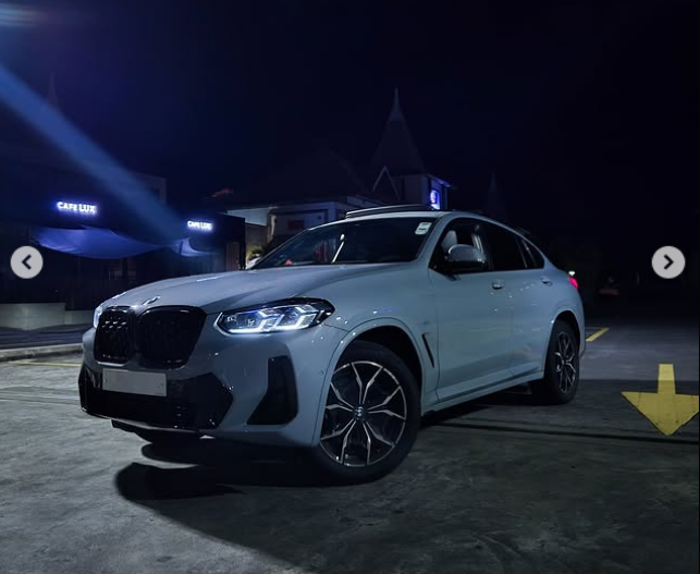 Indian couple driving a Mini Cooper Convertible along the Mauritius coastline