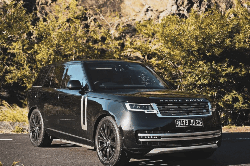 Premium SUV Rental in Mauritius: 2025 Range Rover Vogue P400 parked on a scenic coastal road in Mauritius with turquoise lagoon backdrop